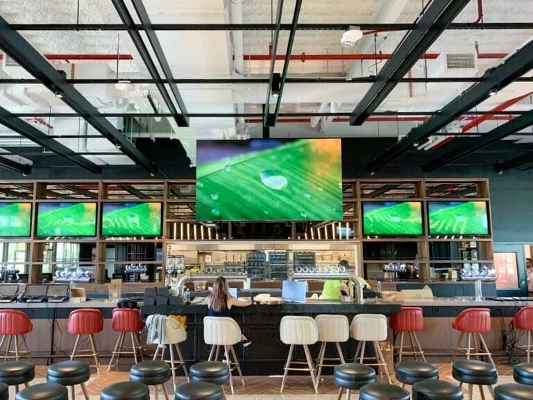 This is an image that showcases an indoor LED Display installed in a restaurant bar as an indoor led commercial display. This is a Hospitality Digital Display Solutions by Metrospec.