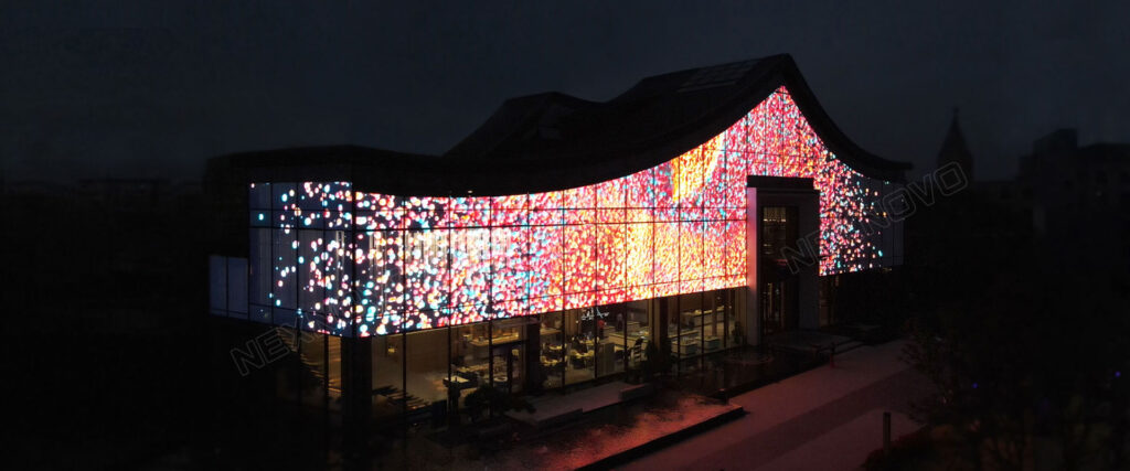 This is an image of a transparent LED screen installed behind the glass facade of a building.