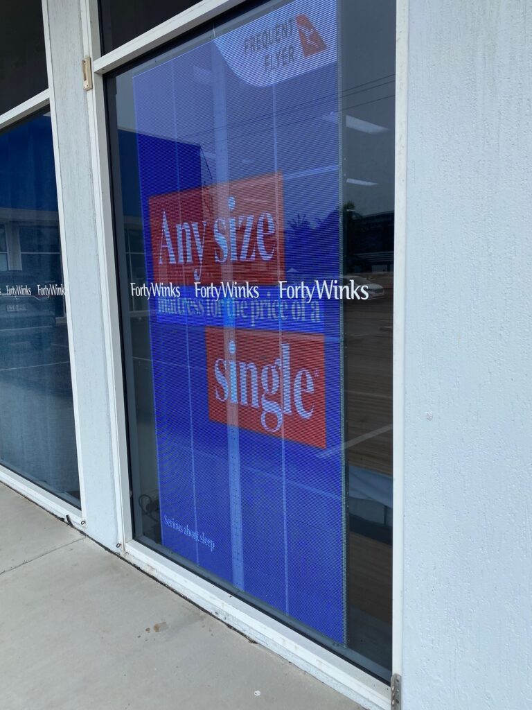 This is an image of the Metrospec Transparent LED Display used for Retail Advertising in Kawana, QLD at Forty Winks Shop Front