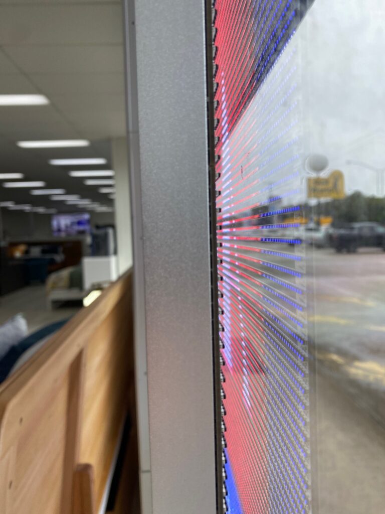 This is an image of the Metrospec Transparent LED Display used for Retail Advertising in Kawana, QLD at Forty Winks Shop Front