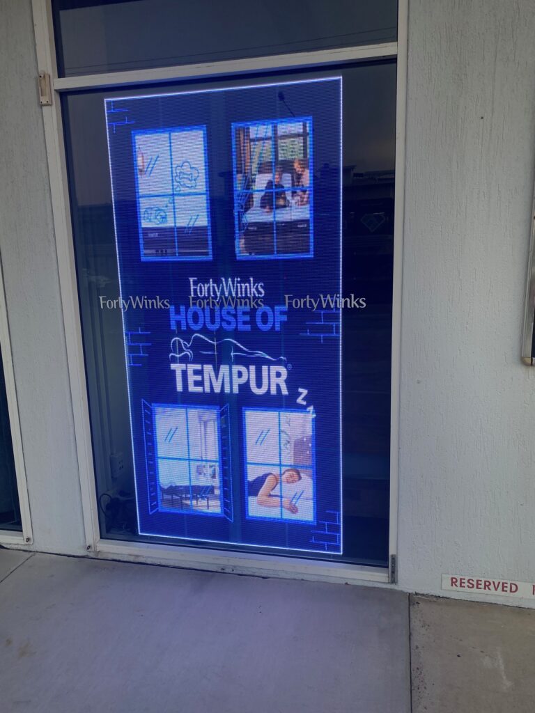 This is an image of the Metrospec Transparent LED Display used for Retail Advertising in Kawana, QLD at Forty Winks Shop Front
