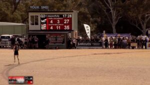 Outdoor Football Club LED scoreboard at Kilsyth Football Club displaying live Australian rules football scores during a match.