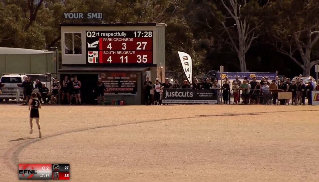 Outdoor Football Club LED scoreboard at Kilsyth Football Club displaying live Australian rules football scores during a match.